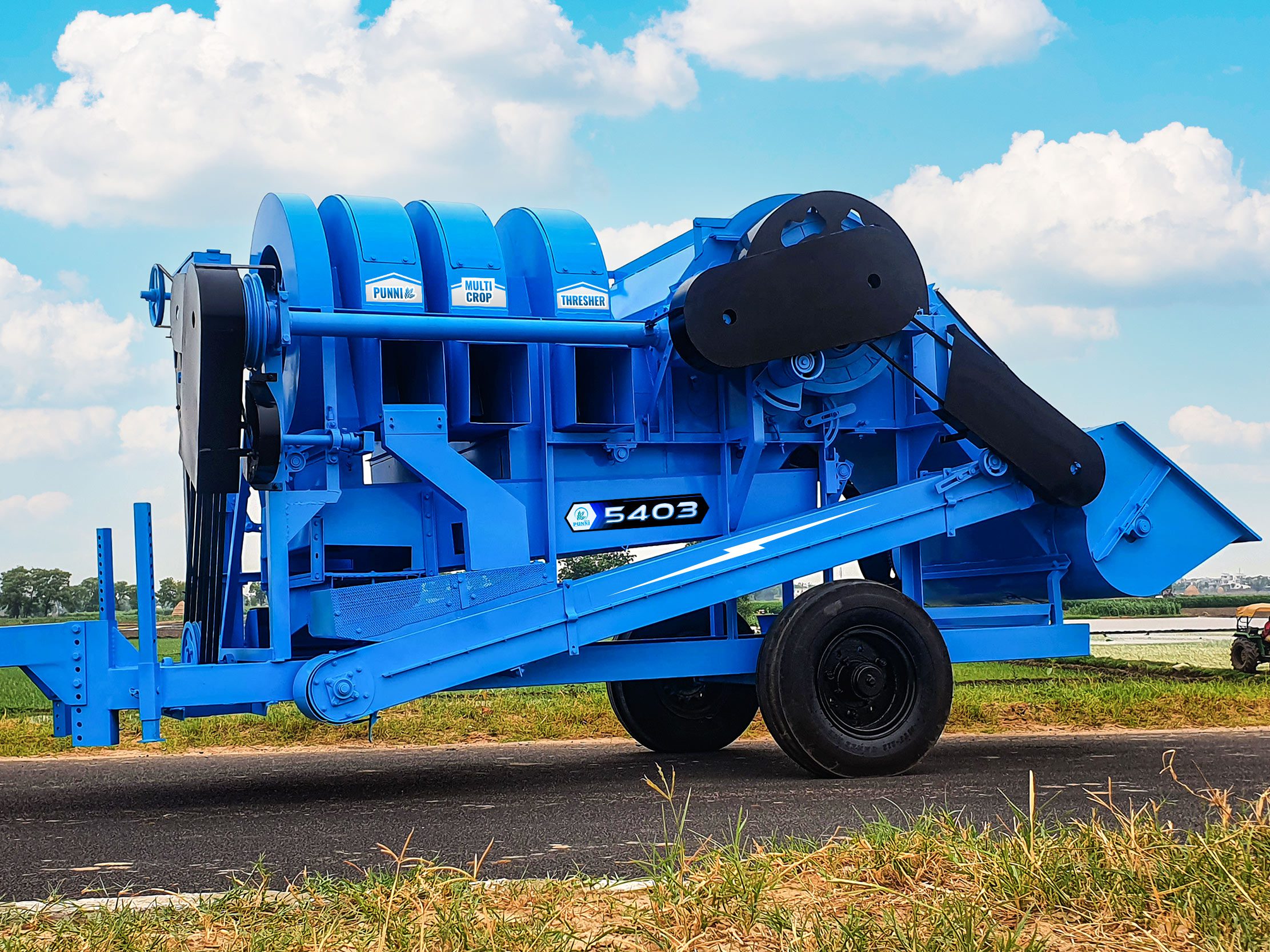 A high-quality image of the PUNNI 5403 multi-crop thresher in action, efficiently separating grain from crops.